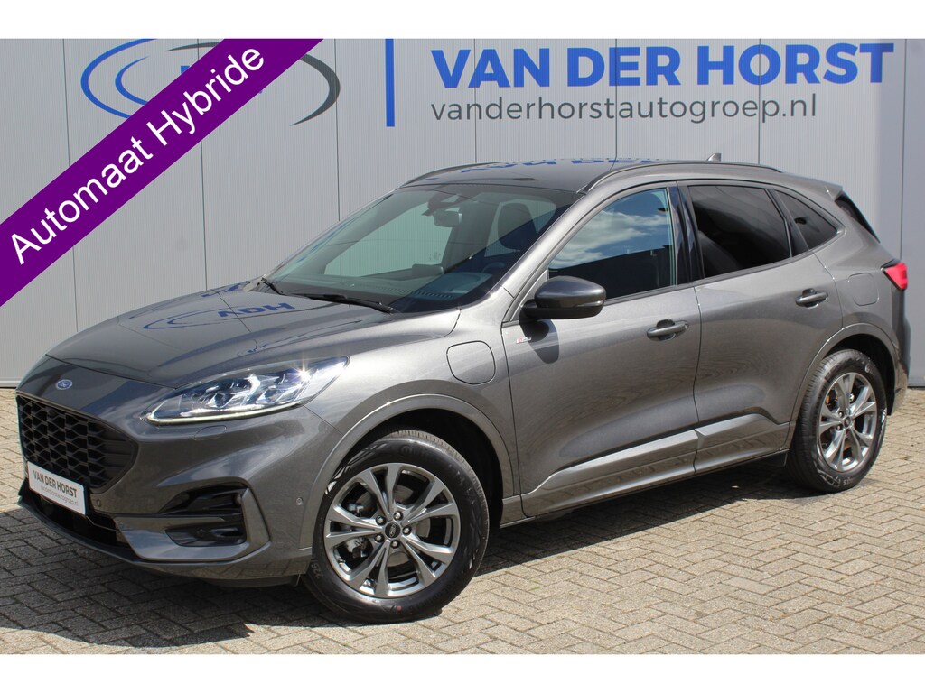 Ford Kuga 2.5-225pk Plug-in Hybrid ST-Line X. Hybride rijden voor een reële prijs ! Autm. airco dual, side- en lane assist, adaptieve cruise cntrl, camera v+a, stoel- en voorraamverw., elektr. achterklep, metallic lak, navigatie, telefoonvoorb.