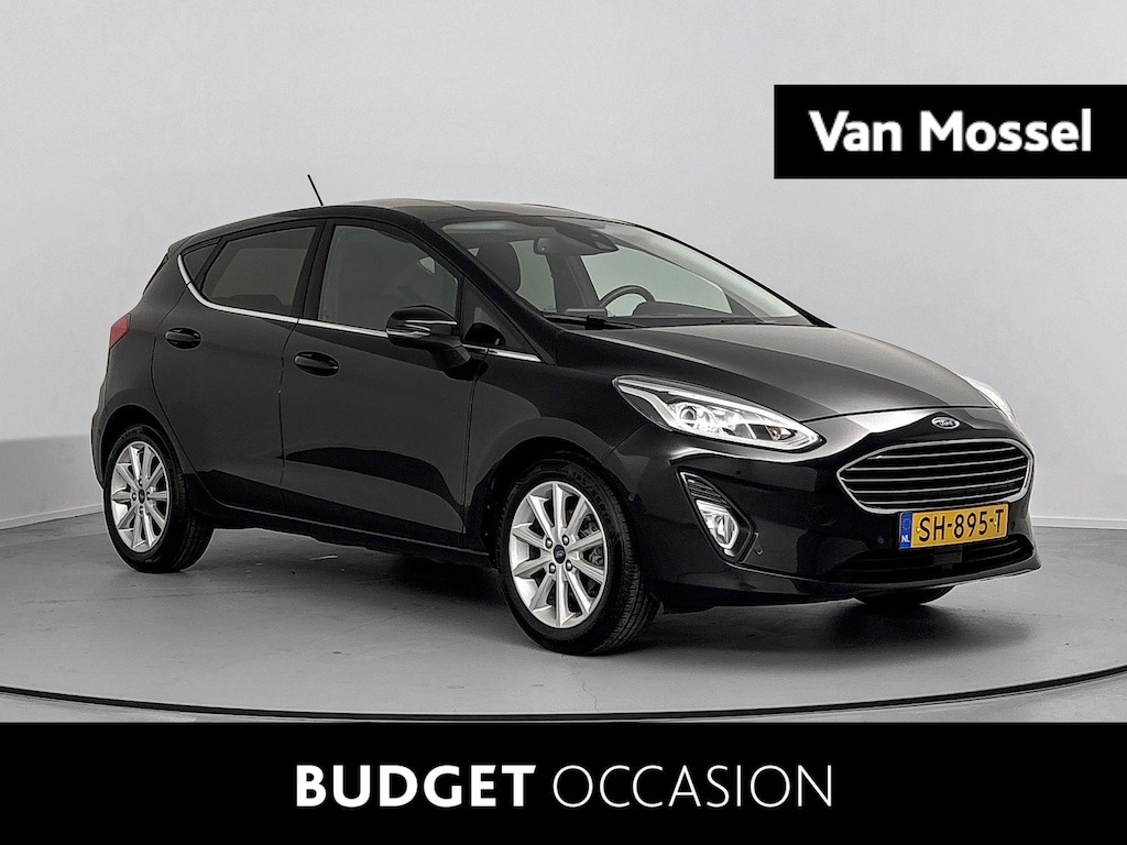 Ford Fiesta 1.0 EcoBoost Titanium Airco | Apple Carplay/Android Auto | Bluetooth | Cruise Control | Hill Hold Functie | LED Dagrijverlichting | Lichtmetalen Velgen 16'' | Multimedia-Voorbereiding | Regensensor | Rijstrooksensor | Sportstoelen | Spraakbediening | Start/Stop Systeem | Vermoeidheidsherkenning