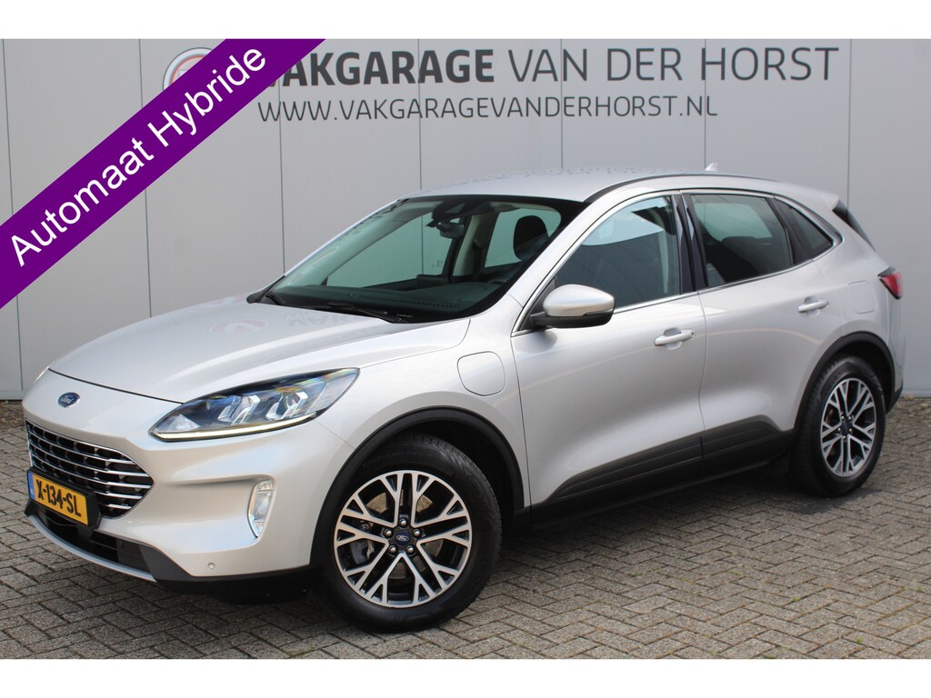 Ford Kuga 2.5-225pk PHEV Titanium. Hybride rijden voor een reëel bedrag ! Autm. airco dual, stoel-, stuur-, achterbank- en voorraamverw., navigatie, telefoonvoorb., trekhaak, metallic lak, LM wielen+ AllSeason banden etc.