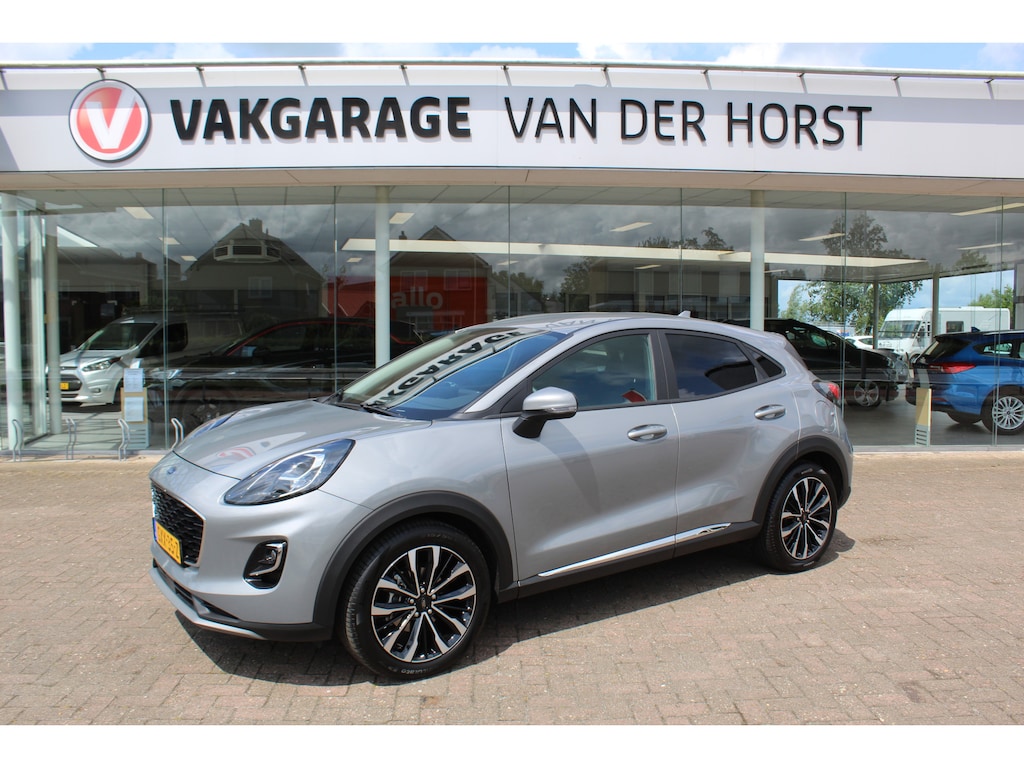Ford Puma 1.0-125pk EcoBoost Mild-Hybrid Titanium X. Garantie t/m 07-03-2028 ! Slechts 7.400km ! Cruise cntrl, climate cntrl, stoel-, stuur- en voorraamverw., draadloos opladen telefoon, trekhaak afneembaar, navigatie, telefoonvoorb., LM wielen, B&O soundsyst., digitaal dashboard etc.