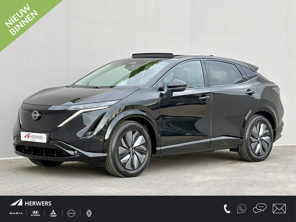 Nissan Ariya e-4ORCE Evolve 91 kWh 4WD / 306 PK / Leder / 1.500 kg Trekgewicht / Warmtepomp / 10 jaar Nissan More Garantie / Stoelverwarming voor en achter / Schuif-kantel dak / HUD / Stoelventilatie / Stuurverwarming / Rondomzicht camera / Elektrisch verstelbare stoelen met geheugen / Elektrische achterklep / Adaptieve cruise control / Apple Carplay/Android Auto /