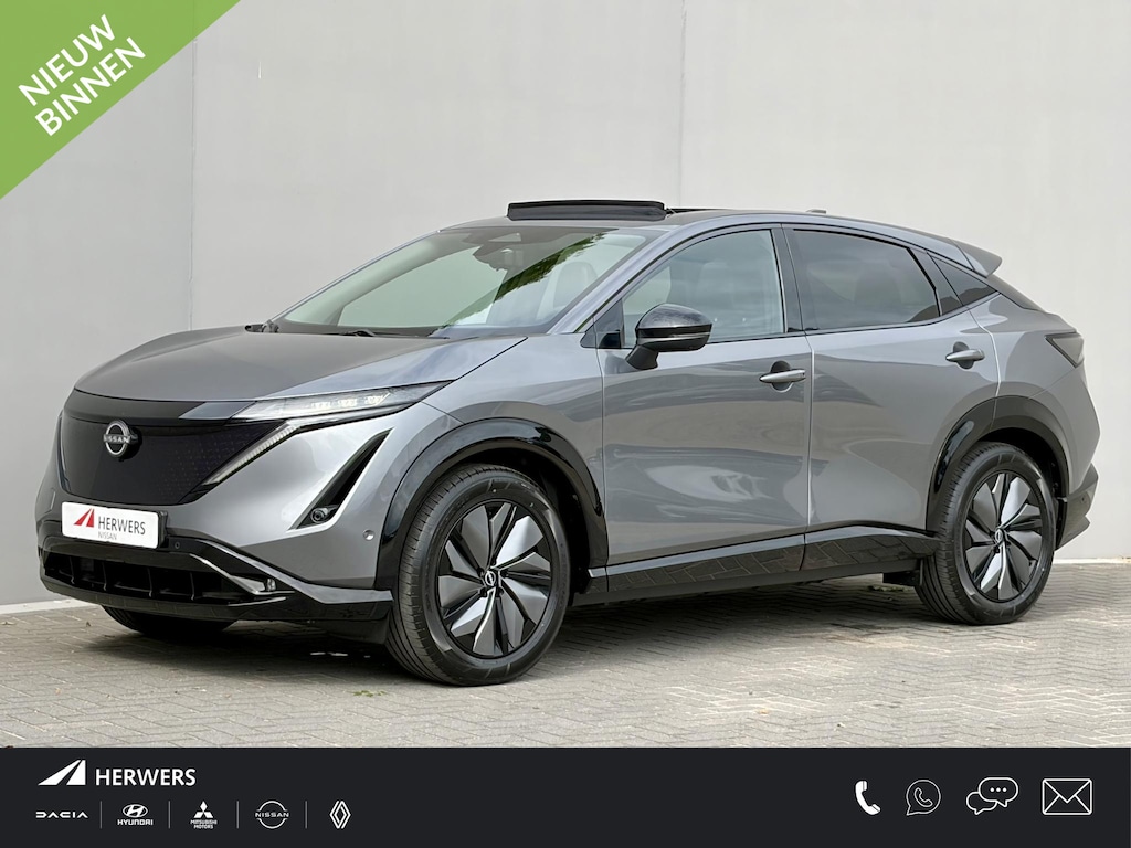 Nissan Ariya e-4ORCE Evolve 91 kWh / 4WD / Leder / Head- Up Display / Warmtepomp / 10 Jaar Nissan More Garantie / Stoelverwarming voor en achter / Schuif-Kantel Dak / Stoelventilatie / Stuurverwarming / Rondomzicht camera / Elektrisch Verstelbare Stoelen met Geheugen / Elektrische Achterklep / Adaptief Cruise Control / Apple Carplay & Android Auto /