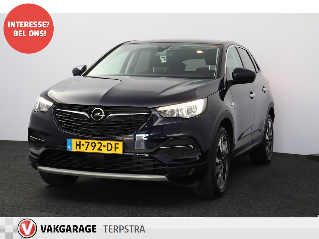 Opel Grandland X 1.2 Turbo Business Executive/ D-Riem verv: 55.000 KM!/ Automaat!/ Trekhaak/ 18'' LMV/ Panorama-Dak/ Elek. Kofferklep/ Apple + Android/ Dode-Hoek DET./ Extra getint glas/ Chroom/ Adaptive Cruise.