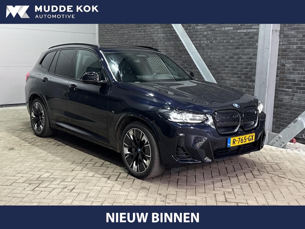 BMW iX3 High Executive 80 kWh | Harman/Kardon | Trekhaak | Head-Up | Parkeerassistent Plus | Adaptief M-onderstel | Stoel+Stuurverwarming | 20 Inch