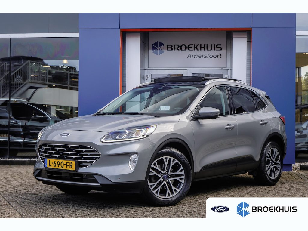 Ford Kuga 1.5 EcoBoost Titanium | Trekhaak/1800kg trekgewicht | Panoramadak | Head-up | Apple Carplay/Android Auto | Stoel/stuur/voorruit verwarming | Elektrisch bedienbare achterklep | Keyless | Apple Carplay/Android Auto|telefoonintegratie premium | Cruise control | Elektrisch bedienbare achterklep met sensorsturing
