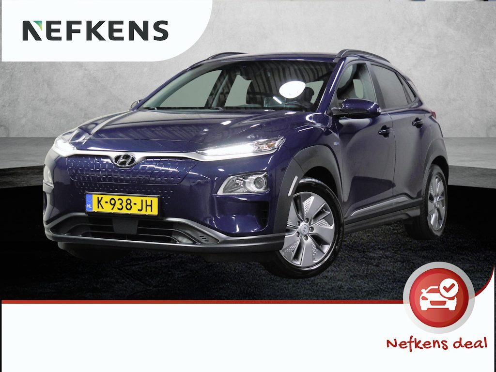 Hyundai Kona Fashion 64kWh 201PK | 1ste eigenaar | ACCU 94% | AppleCarplay/AndroidAuto | Adaptief Cruise Control | Trekhaak | Dodehoekdetectie | Camera | Keyless | AUTOMAAT | Isofix | Privacy Glass | Warmtepomp |