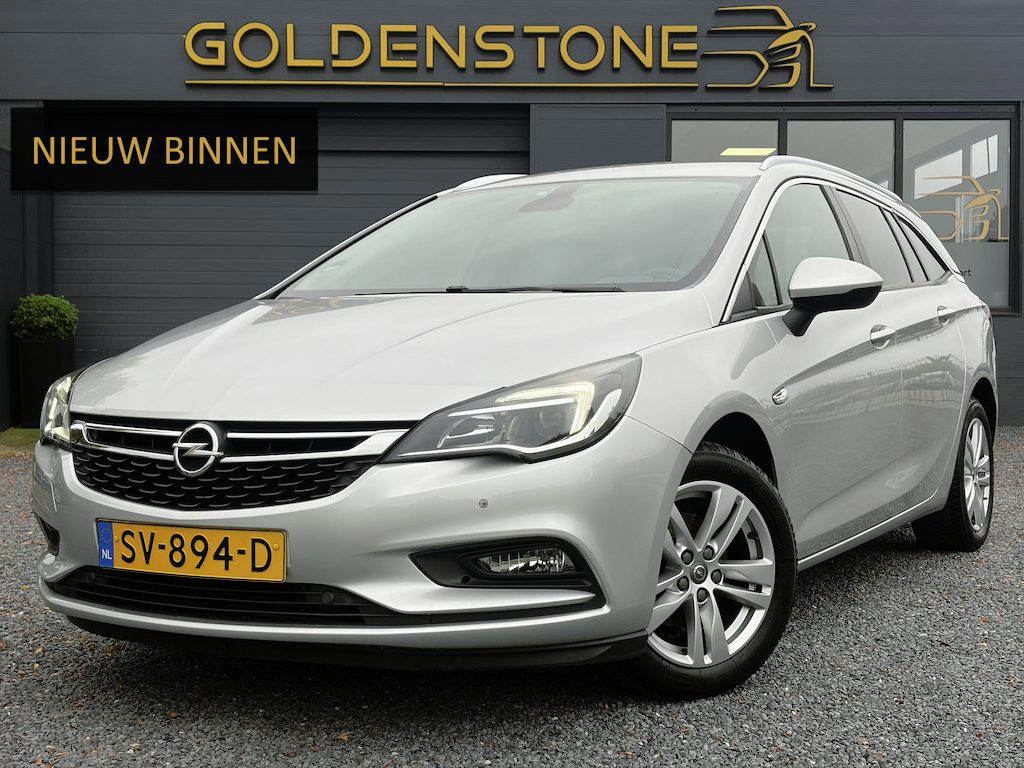 Opel Astra Sports Tourer 1.4 Online Edition ✓2e Eigenaar✓Trekhaak✓Carplay✓Navi✓Recent beurt gehad✓150pk✓Dealer Onderhouden✓6 Bak✓Pdc V+A✓Lm velgen✓Clima✓Cruise✓N.A.P✓Apk tot 06-2027