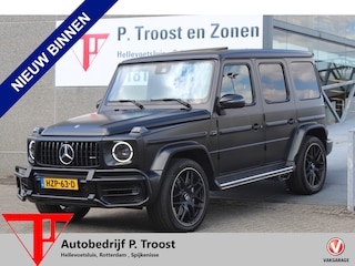 Mercedes-Benz G-klasse 63 AMG Night pakket/Magno matt/Panoramadak/Burmester audio/Sfeerverlichting/Entertainment schermen achter/Akrapović/AMG active ride control/Elektrisch verstelbare stoelen met memory + massage/Stoel verwarming + koeling/360° camera/voorruitverwarming/IWC