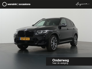 BMW X3 xDrive30e High Executive | M-Pakket | Trekhaak | Sportstoelen | Panoramadak | HUD | Harman/Kardon Audio | Adaptieve Cruise Control | Ele. verstelbare stoelen + geheugen | 360 Camera | DAB | Apple CarPlay/ Android Auto |