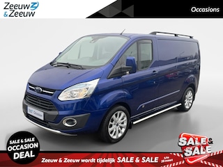 Ford Transit Custom 270 2.2 TDCI L1H1 Anniversary Edition 125 PK | 18" LM velgen | Achteruitrijcamera | Parkeersensoren | Trekhaak | Dakreling | Sidebars | Stoelverwarming | Euro V