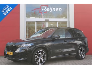 BMW X5 xDrive50e 490PK M-SPORT | PANORAMA SCHUIF/KANTEL DAK "SKY LOUNGE" | COMFORT STOELEN ELEKTRISCH VERSTELBAAR MET GEHEUGENFUNCTIE EN VERWARMBAAR VOOR EN ACHTER | LEDEREN BEKLEDING BMW INDIVIDUAL ZWART | EDELHOUT INTERIEURLIJSTEN | RIJASSISTENT-SYSTEEM DRIVING ASSISTANT PROFFESIONAL MET O.A. DODEHOEK DETECTIE EN ADAPTIVE CRUISE CONTROL | TRAVEL PAKKET | INNOVATIE-PAKKET: PARKEERASSISTENT-PAKKET PROFESSIONAL/ADAPTIEVE LED KOPLAMPEN/HARMAN/KARDON AUDIO SYSTEM/BMW LIVE PROFESSIONAL/RIJASSISTEN-SYSTEEM BMW GESTURE CONTROL/RIJSTROOK ASSISTENT/RIJSTROOKWISSEL ASSISTENT/BOTSWAARSCHUWING/RIJASSISTENT ACHTERBOTSING | DRAADLOZE APPLE CARPLAY/ANDROID AUTO | NAVIGATIE | 360° CAMERA | GEKOELDE BEKERHOUDERS | LUCHTVERING | DRAADLOZE TELEFOONLADER | ELEKTRISCH BEDIENBARE ACHTERKLEP | HEAD UP DISPLAY |