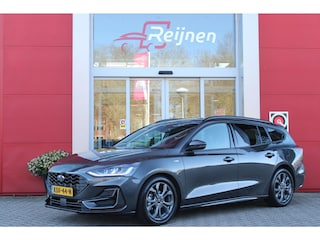 Ford Focus Wagon 1.0 155PK AUTOMAAT Hybrid ST LINE | ALL SEASON BANDEN | NAVIGATIE | DRAADLOZE APPLE CARPLAY/ANDROID AUTO | ADAPTIVE CRUISE CONTROL | LANE ASSIST | DODEHOEK DETECTIE | PARKEERSENSOREN VOOR + ACHTER | ACHTERUITRIJ CAMERA | LICHTMETALEN VELGEN 17" | DAB+ RADIO |