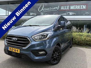 Ford Transit Custom 320 2.0 TDCI L2H1 Platinum Edition DC Automaat Achteruitrijcamera - Parkeersensoren - Navigatie - Airco - Dodehoek detector - Cruise control - Licht metalen velgen 16 inch - Lederen bekleding - Radio - Bluetooth - Dubbele cabine - Tussens - Mistlampen voor - Sidebars - Trekhaak - Voorstoelen verwarmd - Led verlichting - Extra getint glas achter - Start/stop systeem - Stuur multifunctioneel - Stuur leder - Regensensor