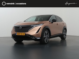 Nissan Ariya Trend Plus 91 kWh | SOH 99% | Trekhaak | Elektrisch verstelbare stoelen + Geheugen | BOSE audio | Stoelverwarming voor + achter | Navigatie | 360 Camera | DAB | Apple CarPlay/Android Auto | Stuurverwarming | Panoramadak | HUD | Adaptieve Cruise Control | Ele. kofferdeksel |