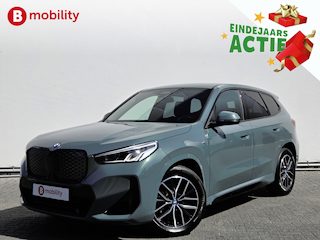 BMW iX1 eDrive20 67 kWh M-Sport SOH 99% Driving Assist. Plus | Sportstoelen | Park Assist | Leer | Adaptive Cruise Control | DAB | NL Auto! | Achteruitrijcamera