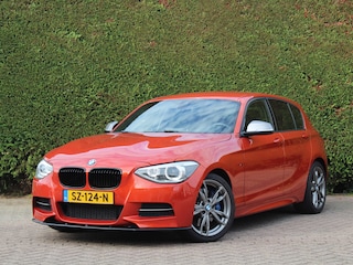 BMW M135i xDrive High Executive | M Performance uitlaat | Valencia orange