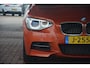 BMW 1-Serie M135i RWD High Executive | Navigatie (Prof) | Leer | Keyless | Dealer onderhouden | Hifi audio | Xenon!! | Uniek!! Top uitgevoerde M135i in Valencia Orange. Destijds geleverd door Hofmeister in Zwaag!!