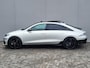 Hyundai Ioniq 6 First Edition AWD 77.4 kWh Automaat / 100% SOH / Origineel NL Auto / tot 04-2009 Fabrieksgarantie / Allseason banden / Schuifkanteldak / 360° camera / Navigatie / Headup Display / Android Auto / Apple Carplay / BOSE audio / Stuur-, voorstoel- en achterbankverwarming /