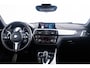 BMW 1-Serie M140i xDrive High Executive Harman Kardon - Elektrisch verwarmde voorstoelen - Sportstoelen - Cruise Control - Achteruitrijcamera - PDC Voor/Achter - Middenarmsteun voor - Adaptieve LED koplampen -