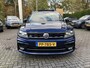 Volkswagen Tiguan 2.0 TDI Highline 150 PK DSG | Automaat | R-Line Exterieur | Trekhaak | Panoramadak | Elektrische Achterklep | Digital Cockpit Pro | Achteruitrijcamera | Stoelverwarming | Navigatie | Climate Control | Park Assist | Adaptive Cruise Control | Grootlicht Assistent | Parkeersensoren | DAB Radio | Bluetooth |