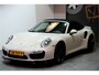 Porsche 911 Cabrio 3.8 Turbo 441kW/600pk PDK7 NL-AUTO!! AKRAPOVIC COMPLEET + SPORT CHRONO + PDLS PLUS + KEYLESS DRIVE + PASM + CAMERA + STOELVERWARMING&-VENTILATIE + BOSE SOUND + TARGET BLUEYE + MOSHAMMER SPOILERPAKKET + PARKSENSOREN V&A + 20" VOSSEN LM-VELGEN!