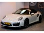 Porsche 911 Cabrio 3.8 Turbo 441kW/600pk PDK7 NL-AUTO!! AKRAPOVIC COMPLEET + SPORT CHRONO + PDLS PLUS + KEYLESS DRIVE + PASM + CAMERA + STOELVERWARMING&-VENTILATIE + BOSE SOUND + TARGET BLUEYE + MOSHAMMER SPOILERPAKKET + PARKSENSOREN V&A + 20" VOSSEN LM-VELGEN!