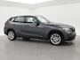 BMW X1 sDrive20i 184 PK AUT. ORIG. NL *94.700 KM* + TREKHAAK | NAVI PRO | MINERALGRAU