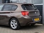 BMW 1-Serie 114i Upgrade Edition | Leder | Schuifdak | Xenon | Sportstoelen | PDC