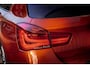 BMW 1-Serie M135i xDrive|Schuifdak|Memory|Valencia Orange|Keyless|M-performance remmerij