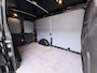 Ford Transit 310 2.0 TDCI L2H2 3-Persoons Camera Airco Stoelverwarming Elek.Stoel Cruise Control Pdc Lane Assist Trend Betonplex Vloer Wandbetimmering Schuifdeur Voorruitverwarming 1e Eigenaar Origineel Nederlandse Bus