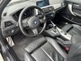BMW 1-Serie 118i High Executive M Sport Shadow / Cruise Control / M-stuur / Apple Carplay&Android Auto / Led Koplampen / Electronic Climate Control / Voorstoelen Verwarmd / Navigatie / Parkeersensoren Voor&Achter / Hifi Speakers