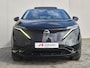 Nissan Ariya Evolve 66 kWh / 99% SOH / Glazen schuif- en kanteldak / CCS snelladen / warmtepomp / Stuur- Stoel & Achterbank verwarming / Head Up Display / Adaptief cruise control / Stoelventilatie / Bose Audio Systeem / Elektrische achterklep / Draadloze telefoon lader /