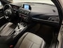 BMW 1-Serie 116i Business+ (PANO, LED, STOELVERWARMING, NAVI, TREKHAAK, HALF LEDER)