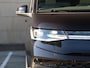Volkswagen Multivan Bulli Edition L2 1.5 eHybrid EU6 180 kW 245pk | 2 Persoons bed | 7 Zits | Navigatie | Trekhaak | Panorama dak | 19 inch Lm velgen | ACC | Apple Carplay | Elek. bedienb. Schuifdeuren en achterklep | IQ Light |