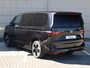 Volkswagen Multivan Bulli Edition L2 1.5 eHybrid EU6 180 kW 245pk | 2 Persoons bed | 7 Zits | Navigatie | Trekhaak | Panorama dak | 19 inch Lm velgen | ACC | Apple Carplay | Elek. bedienb. Schuifdeuren en achterklep | IQ Light |