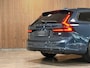 Volvo V90 T6 AWD Recharge Plus Dark | Schuifdak | 360 Camera | Harman Kardon | Adaptieve Cruise Control | Stoelverwarming voor+achter | Stuurwielverwarming | 19 Inch | Full LED Meesturende koplampen | Pilot Assist | BLIS Dode Hoek Detectie | Elektrische voorstoelen geheugen | R-Design Contourstoelen Nappa Leder met wit stiksel en bies | Zitting verlenging voorstoelen | Lederen Dashboard | Google Infotainment | Keyless Drive | Parkeersensoren voor+achter | Privacy Glass | Elektrisch bedienbare achterklep | Geïntegreerde zongordijnen achterportieren | Verlichte instaplijsten | DAB Radio | Apple Carplay/Android Auto | Alarm Klasse III | Volvo On Call met mobiele App functie | Denim Blue Black Metallic |