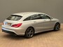 Mercedes-Benz CLA Shooting Brake 180 OrangeArt Edition Leder/Stof Sportstoelen | Stoelverwarming | Parkeersensoren Rondom | Airco | Cruise | 17" Lichtmetaal | 360° Parkeersensoren | AMG-styling | Airco