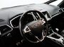 Ford S-Max 1.5 ST-Line 7p. Apple Carplay/Android Auto, Cruise control, Verwarmde voorruit, Parkeersensor voor en achter, Een sportieve en ruime gezinsauto die comfort, dynamiek en praktisch gebruiksgemak moeiteloos combineert. De 1.5 EcoBoost-benzinemotor biedt vlotte prestaties, terwijl de zeven zitplaatsen vo